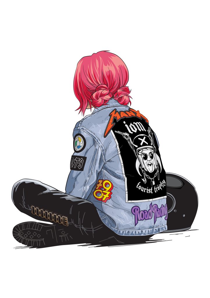 biker girl sitting watching isle of man tt races wearing denim jacket with tt course music themed patches